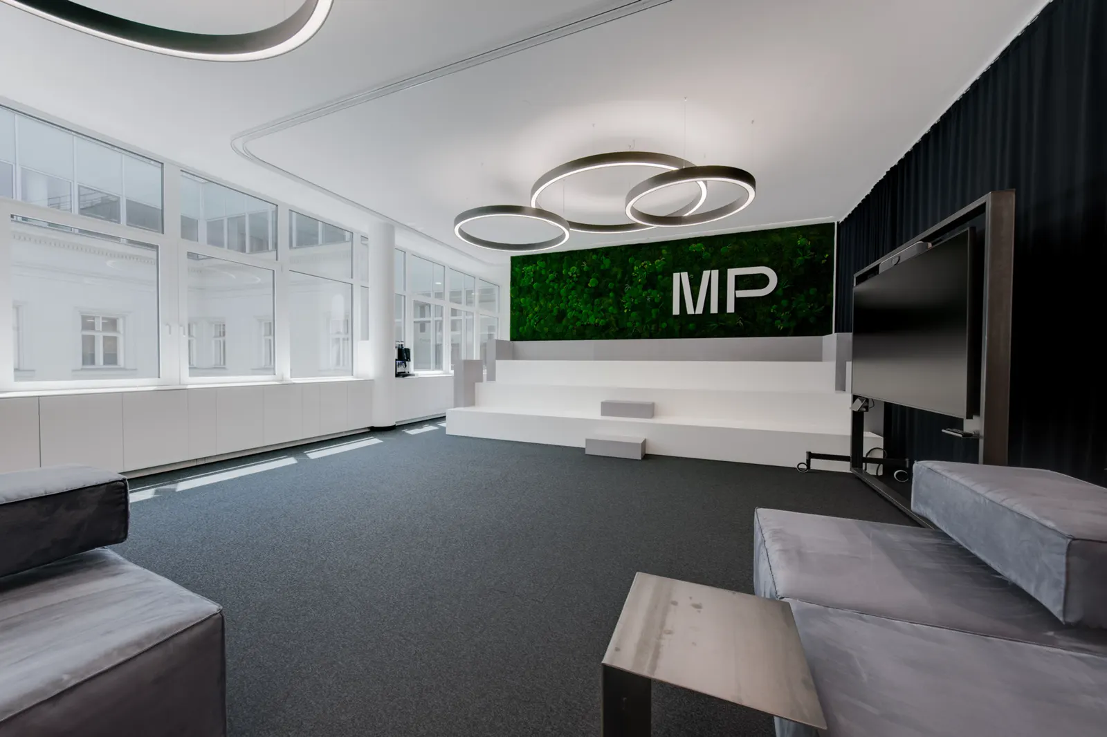 Open-plan office with moss wall and lounge