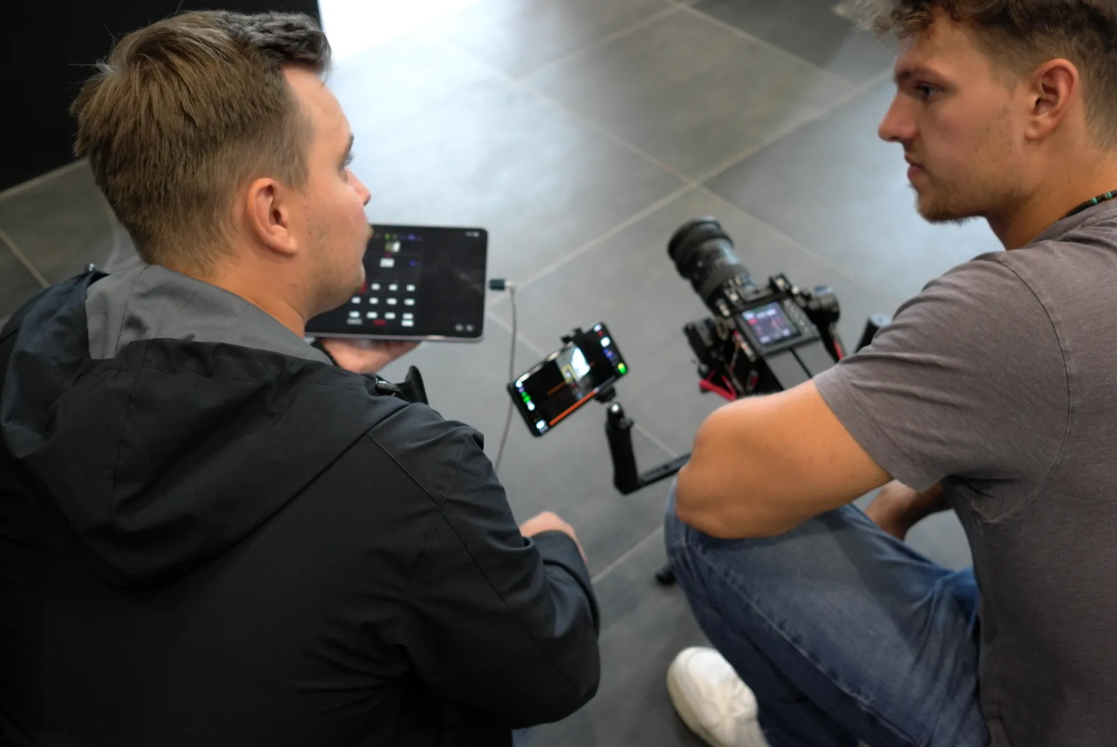 Dennis discussing the image on a tablet with a camera operator