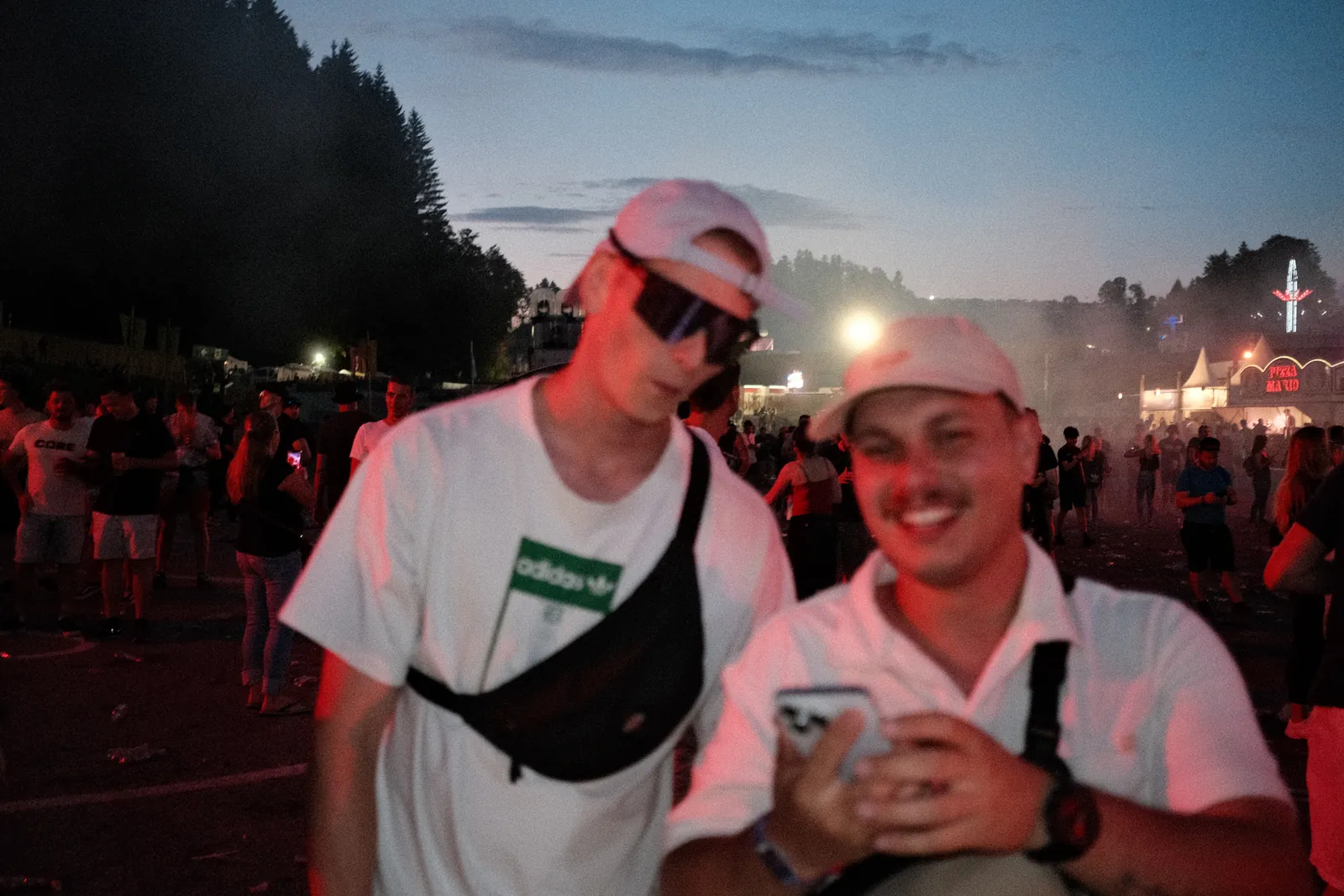 Dennis with a friend at a festival at dusk